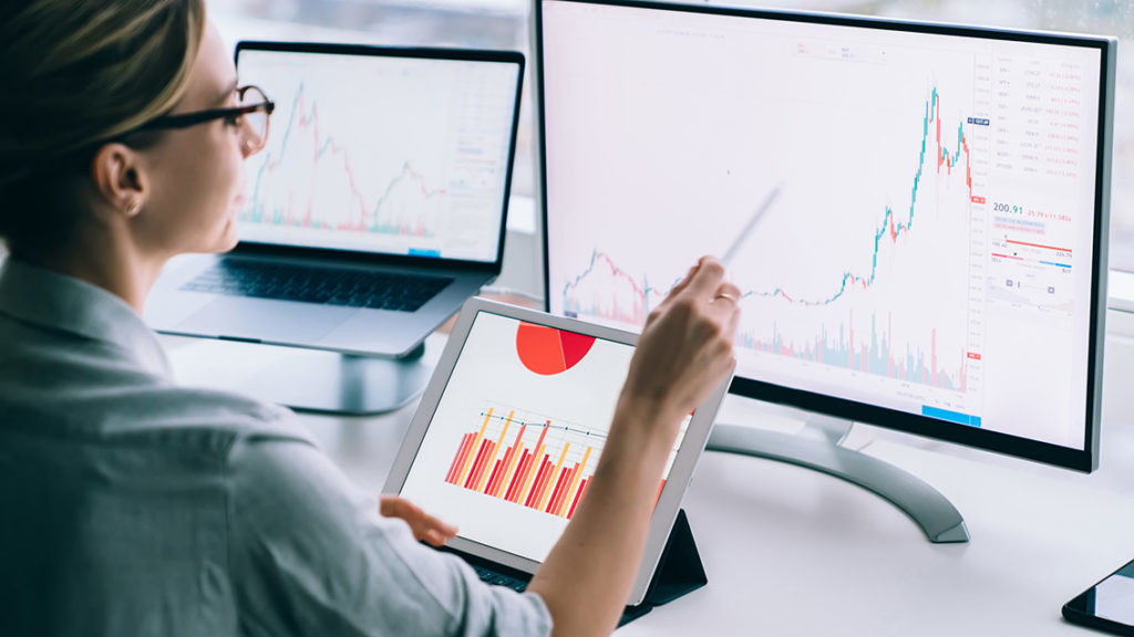 Crop businesswoman researching charts on computer